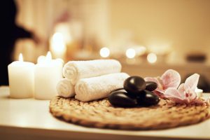 towels, stones and flowers are on table 